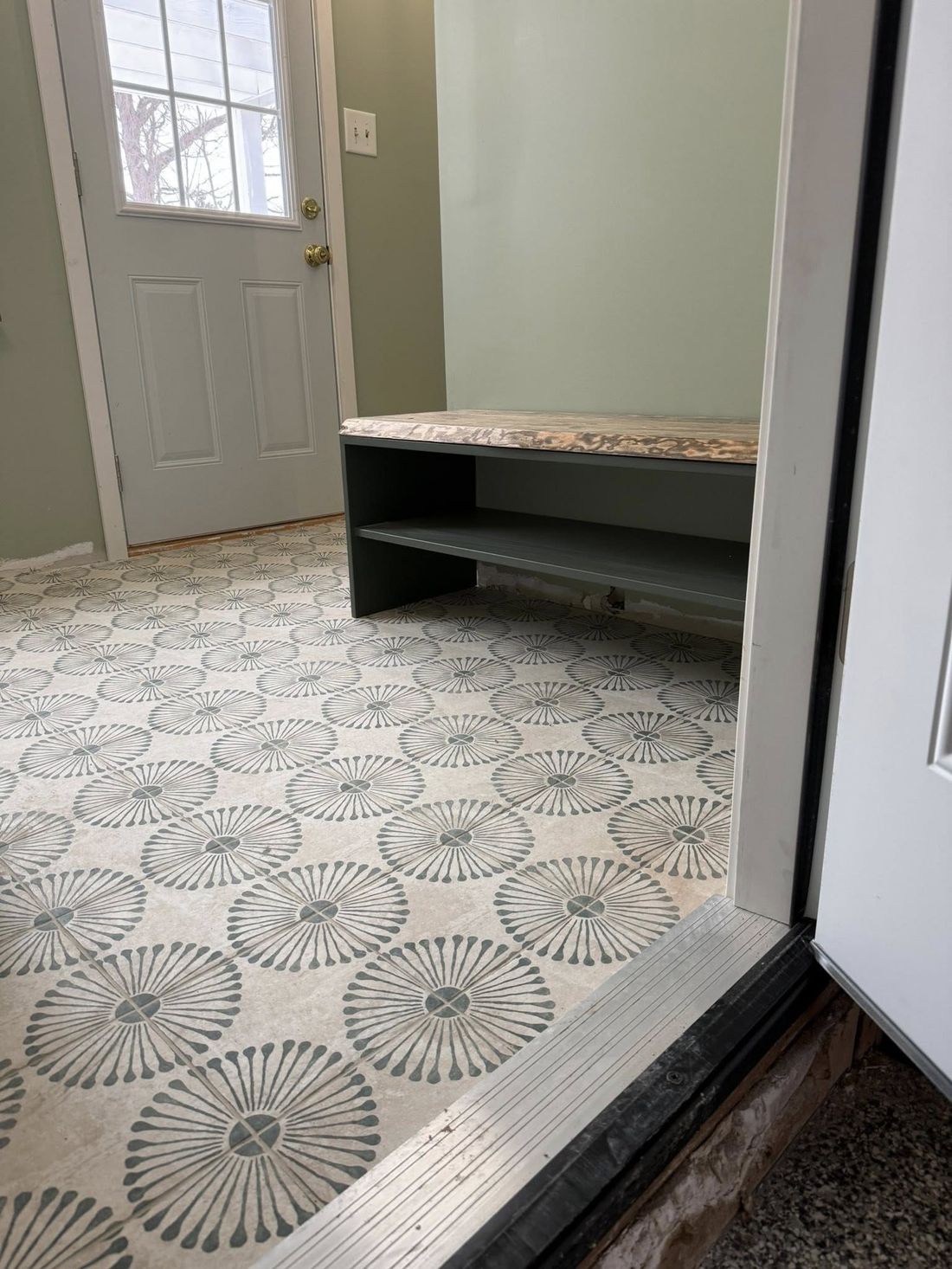 Finished live-edge storage bench installed in a mudroom